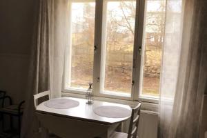 a bathroom with two sinks in front of a window at Viehättävä yksiö merellisessä Kotkassa. in Kotka +13 photos