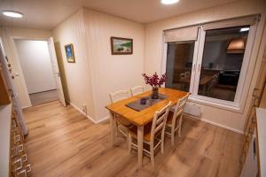 a dining room with a wooden table and chairs at Sea view Holmestrand sauna and hot tube appartment in Holmestrand