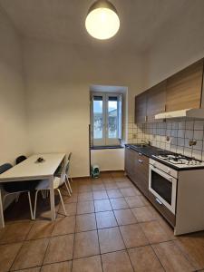 a kitchen with a table and a table and a dining room at B&B Ambra in Sarno