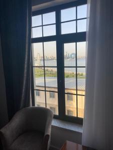 a chair in front of a window with a view of a building at Jupiter in Baku