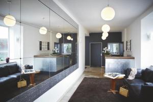 a living room with couches and a table and mirrors at Hotel Tannhäuser in Heidelberg