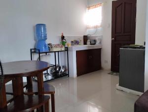 a small kitchen with a table and a counter top at Vin's Place Rentals in Tagum