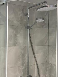 a shower with a glass door in a bathroom at Newly Build 2BR Property with free parking in High Wycombe