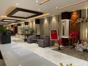 een lobby met banken en een bord in het midden bij Hotel Paradise Dream in Ludhiana