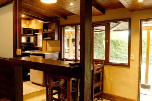 a kitchen with a large wooden island in a room at Cabañas Recanto in Mar del Plata