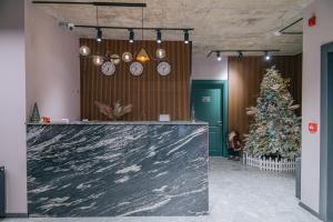 a lobby with a christmas tree and clocks at Forest Villa in Goderdzi