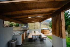 an outdoor kitchen with a table and a stove at Cabana A-Frame NorthLand in Borşa