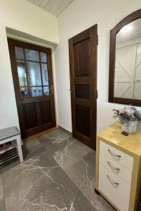 a room with two doors and a counter with flowers on it at Apartmánové ubytovanie POD DUBOM in Poľný Kesov