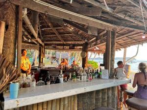 a bar with a counter full of bottles at Koh Kood Cabana in Ban Lak Uan