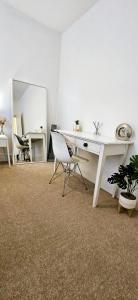an office with a desk and a chair and a mirror at 1 bedroom flat in Gravesend in Kent