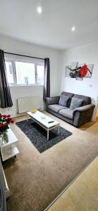 a living room with a couch and a coffee table at 1 bedroom flat in Gravesend in Kent