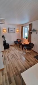 a living room with two couches and a table at Sifferbo Stugby in Sifferbo
