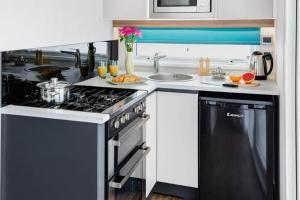 a kitchen with a stove and a sink at The CaraPod & HotTub - KINTYRE in Tarbert