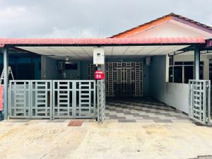 a building with a gate in front of a garage at Sehijau Homestay Kangar in Kangar