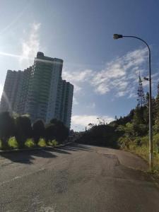 a street light on the side of a road with a tall building at Golden Hill Resort Genting Highland in Genting Highlands