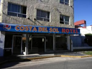 a building with a sign for a del sol hotel at Costa del Sol in San Clemente del Tuyú
