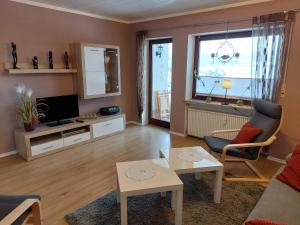 a living room with a couch and a tv at Sonnenhang in Großalmerode