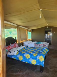 a bedroom with two beds in a room at ilkerin camp maasai mara in Sekenani