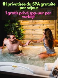 a man and a woman sitting in a hot tub at Le Bras d'or Apparts et Spa in Boulogne-sur-Mer