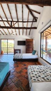 a bedroom with two beds in a room at Hotel AMANEE in Barichara