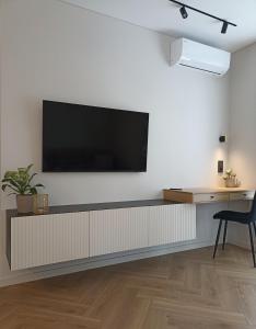 a living room with a flat screen tv on a wall at Apartments with an impressive terrace on the roof of the house in Vilnius