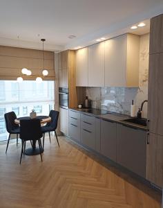 a kitchen with a table and a dining room at Apartments with an impressive terrace on the roof of the house in Vilnius