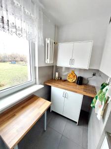 a small kitchen with a table and a window at Kawalerka z prywatną łazienką i kuchnią in Gdańsk