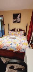 a bedroom with a bed with a colorful comforter at Fox Lodge in Drogheda