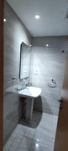 a bathroom with a white sink and a mirror at درة المكرونة للوحدات السكنية - Durrat Al-Makarona Residential Units in Jeddah