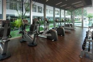 een fitnessruimte met rijen loopbanden en crosstrainers bij Elio Sukhumvit 64: Chic Space in Bangkok