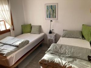 a bedroom with two beds and a lamp on a table at M&M Relax apartman in Torrevieja