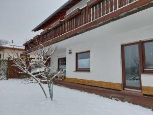 a house with snow in front of it at Sonnenhang in Großalmerode