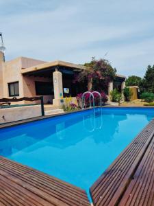 a swimming pool in front of a house at Villa Turquoise Formentera in Sant Ferran de Ses Roques
