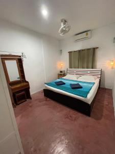 a bedroom with a bed and a mirror in it at Just sleep in Ban Mo Nae