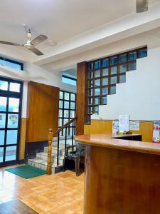 a lobby with a bar and a staircase with windows at Hotel Sova's Inn in Birātnagar