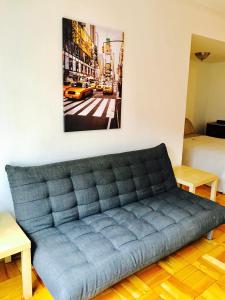 a couch in a room with a picture on the wall at Stylish Montreal Apartment: Comfortable Stay in the Golden Square Mile in Montreal