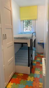 a bunk bed in a room with colorful floors at Gran sol de la Farella in Llança