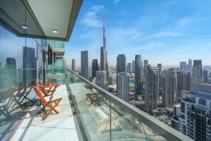a glass balcony with a view of a city at Luxurious one bedroom Apartment in Dubai