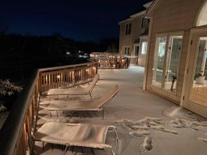 a group of benches sitting on a deck at night at The Retreat at Davis Mill in Germantown