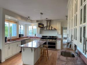 a large kitchen with white cabinets and a large island at The Retreat at Davis Mill in Germantown