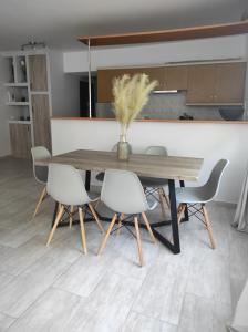 a dining room table with four chairs around it at Villa kontes kefalonia in Kardhakáta +24 photos
