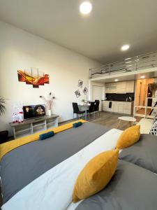 a bedroom with a large bed and a living room at VIT Apartment - Free Parking - O2 Arena in Prague