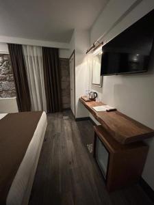 a hotel room with a bed and a desk at ASSOS TROY PORT HOTEL (+8) in Ayvacık