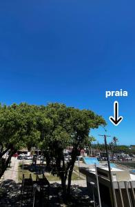 a tree in front of a parking lot at Hotel Morada de Leste in Pontal do Paraná