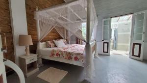 a bedroom with a bed with a canopy at Walauwa on the hill in Hatton