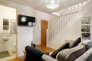 a living room with a couch and a tv at Cute Duplex Apartment in Leeds in Kirkstall