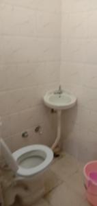 a bathroom with a toilet and a sink at Utterkashi Prithvi yatra hotels in Uttarkāshi