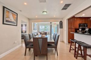 a kitchen and dining room with a table and chairs at Luxurious 5 bedrooms Jacuzzipool in Miramar