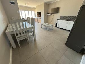 a kitchen and dining room with a table and chairs at Oceana Hondeklipbay in Hondeklipbaai