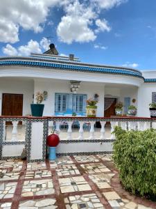 Casa blanca con balcón y patio en Slama, en Nabeul